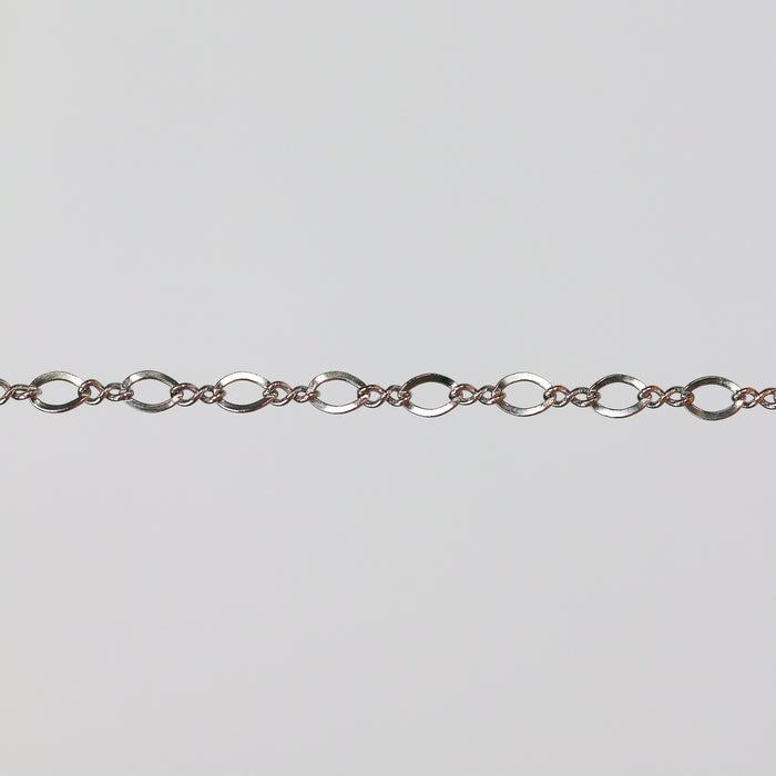 White gold chain with twisted figure 8 links on a light colored background