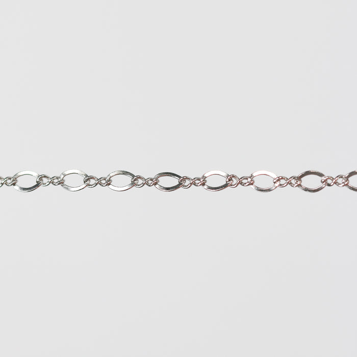 White gold infinity linked pj chain over a light gray background