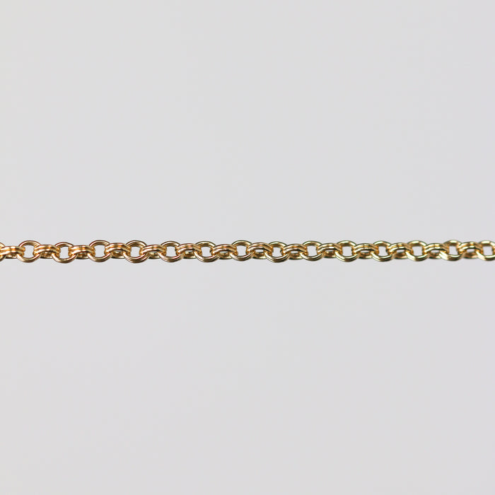 Gold double cable chain on a light gray background