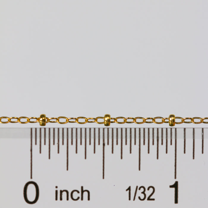 Gold paisley cable chain next to a ruler for measurement