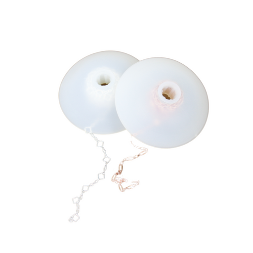 Stored chain on bobbins meant for permanent jewelry.
