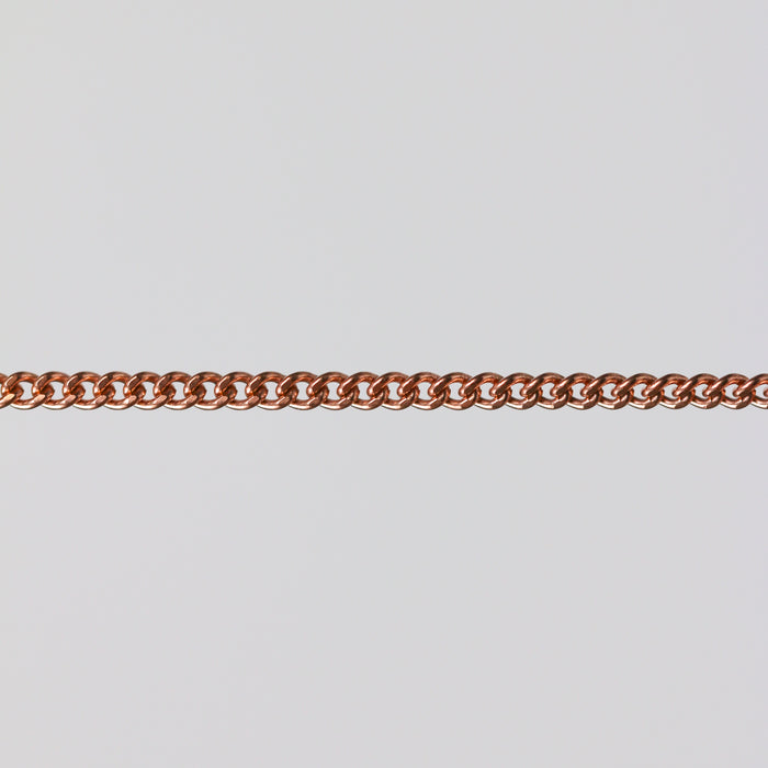 Rose gold curb chain for permanent jewelry on a light gray background