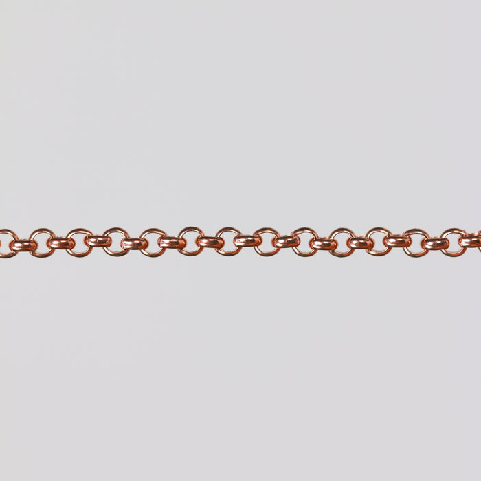 Rolo chain in gold filled rose stretched over a gray background to show the links