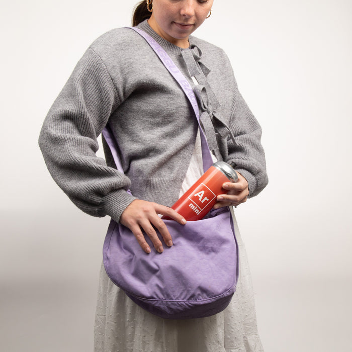 Person carrying a small tank of argon mini gas in their purse