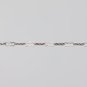 Solid white gold crinkled paperclip chain on a light gray background