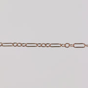 Solid gold paperclip cable chain on a gray background