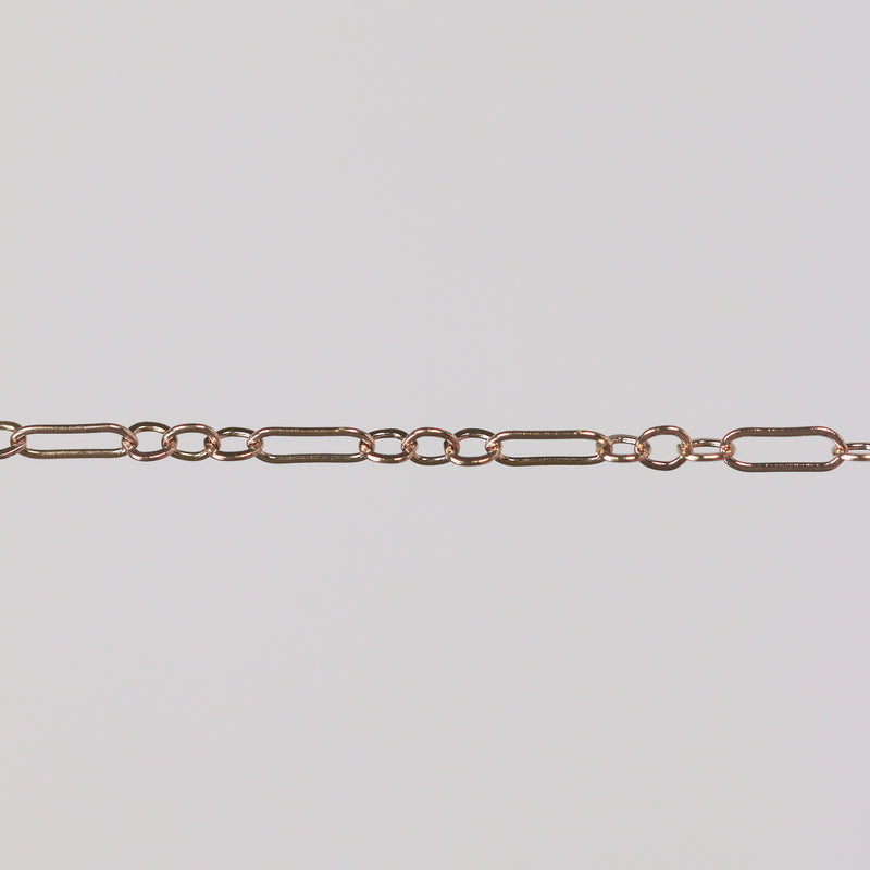 Solid gold paperclip cable chain on a gray background