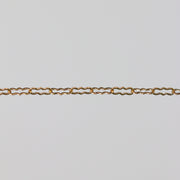Gold paperclip chain on a gray background