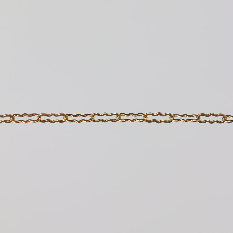 Gold paperclip chain on a gray background
