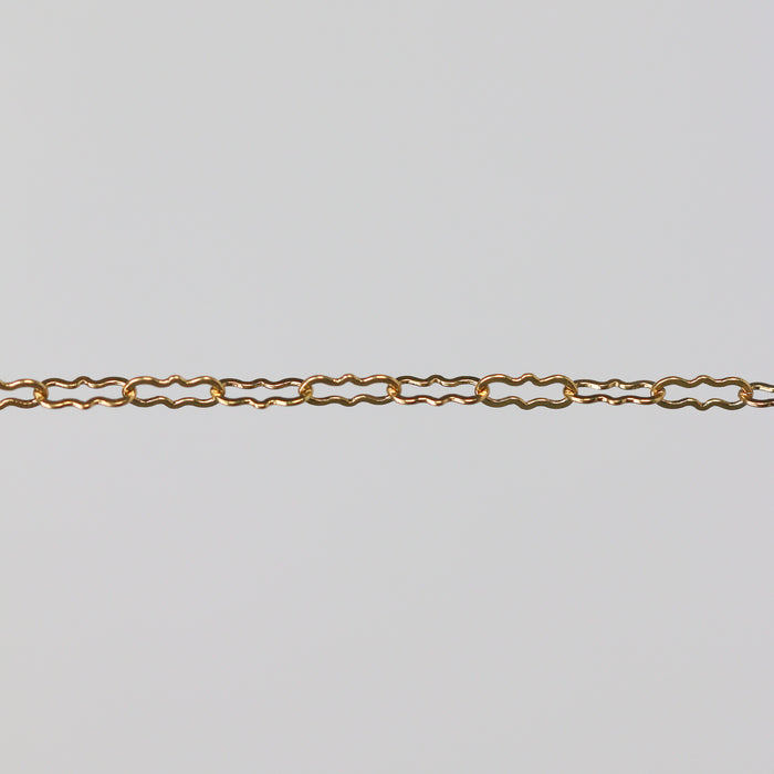 Gold paperclip chain on a gray background