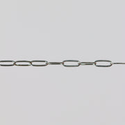 White gold oval paperclip chain on a light gray background