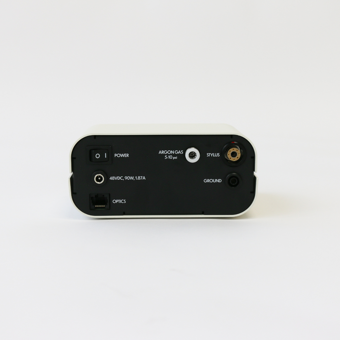 The back of the Zapp Plus 2 permanent jewelry welder showing the power switch, argon gas hookup, removable stylus plug, grounding clip plug, power cable connector, as well as a spot for eye protection optics to be plugged into the welder.