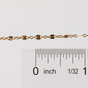 Photo of the Brielle chain in yelllow gold filled up against a ruler to help understand the size of the chain style.