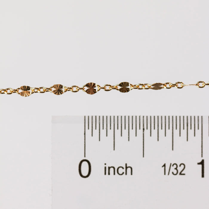 Photo of the Brielle chain in yelllow gold filled up against a ruler to help understand the size of the chain style.