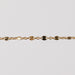 Zoomed in photo of a starburst shiny permanent jewelry chain in yellow gold filled.