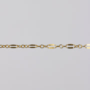 Gold dapped link chain for PJ on a light gray background