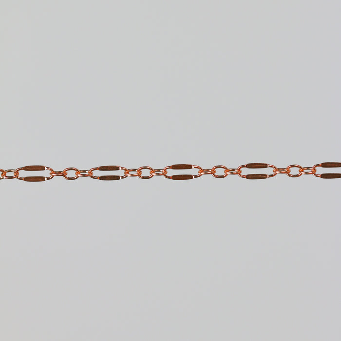 Closeup of the rose gold dapped bryce chain on a light gray background.