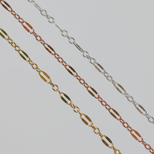 Three chains on a light gray background. The chains are Silver, Rose Gold, and Yellow Gold and have a long dapped link between three short links.