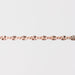Rose gold chain bracelet closeup on a light gray background