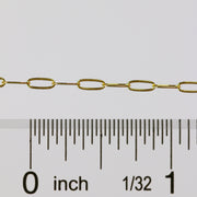 Gold chain with a ruler showing measurements on a white background
