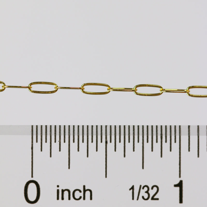 Gold chain with a ruler showing measurements on a white background