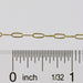 Gold chain with a ruler showing measurements on a white background