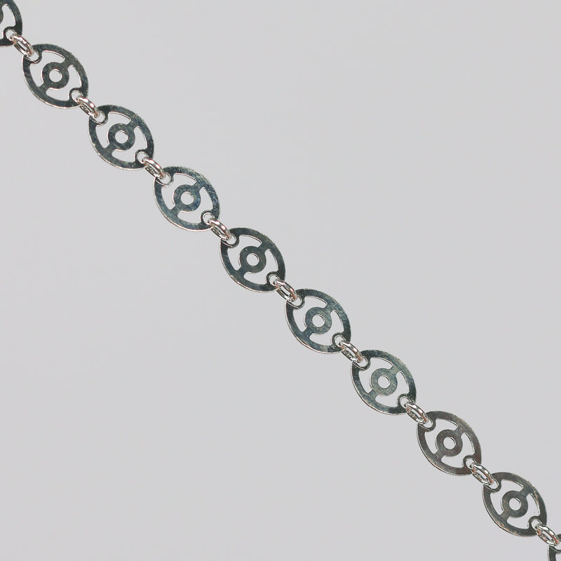 Silver chain with disks linked together. The disks have holes in them that give the chain a light, airy look.