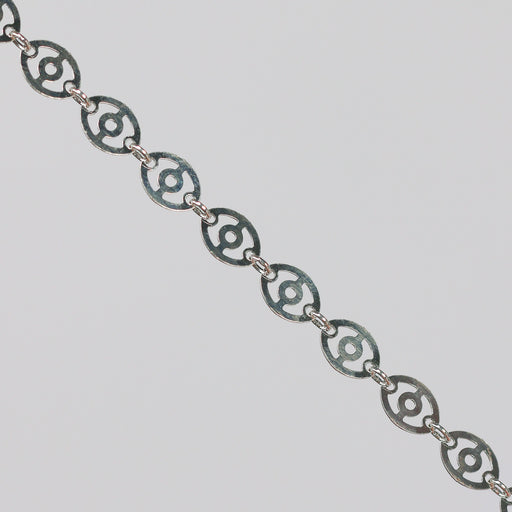 Silver chain with disks linked together. The disks have holes in them that give the chain a light, airy look.
