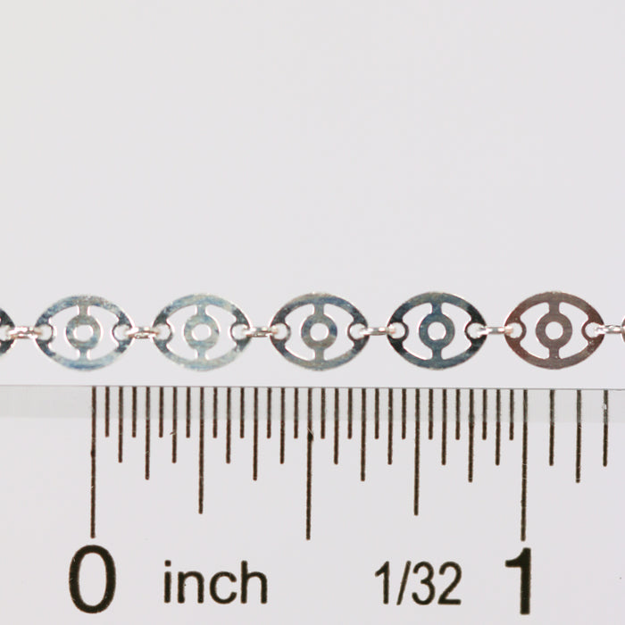 Silver chain against a ruler showing the size and dimension of the chain links and disks on the chain.