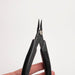 Black pliers held by a hand on a white background