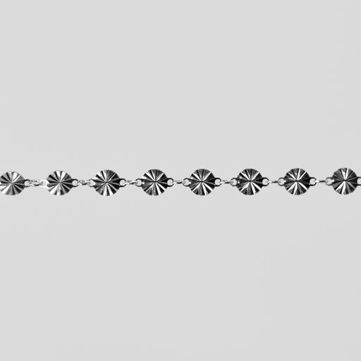 Silver chain with decorative links on a light gray background