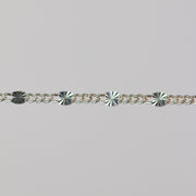 Sterling silver chain with 1 starburst link and three figaro chain links.
