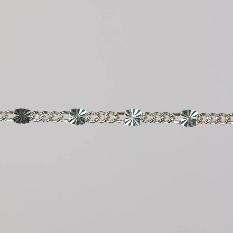 Sterling silver chain with 1 starburst link and three figaro chain links.