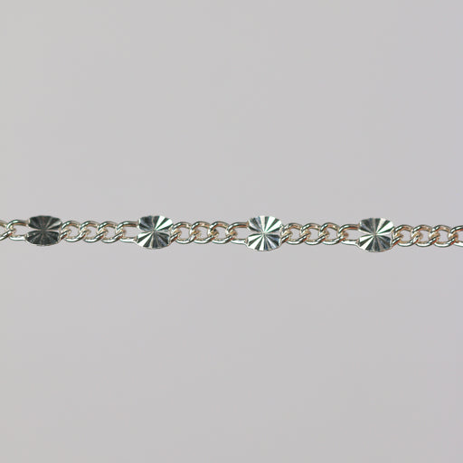 Sterling silver chain with 1 starburst link and three figaro chain links.