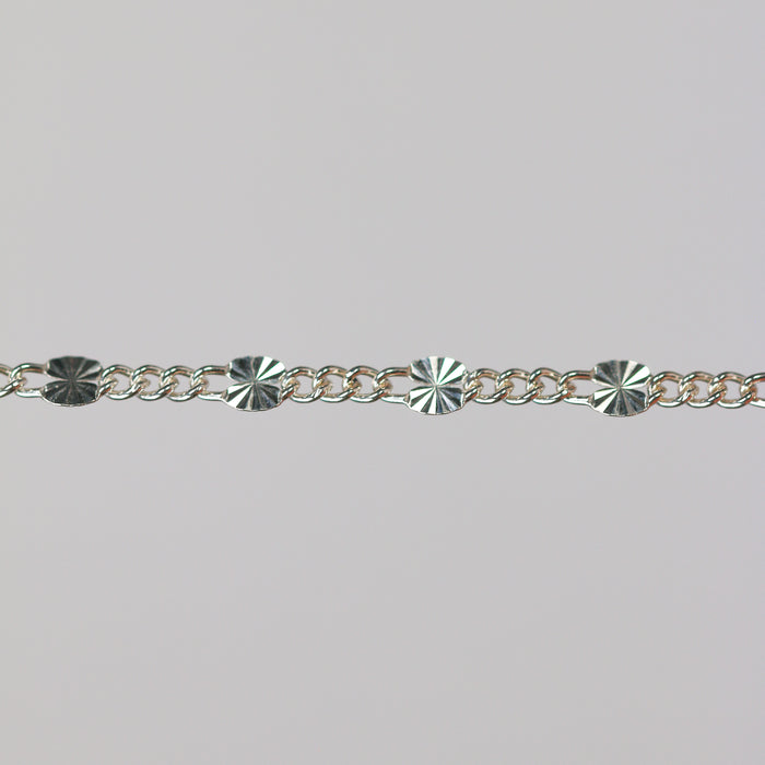 Sterling silver chain with 1 starburst link and three figaro chain links.