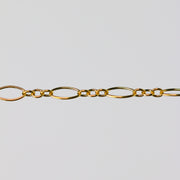 Gold oval chain on a light gray background