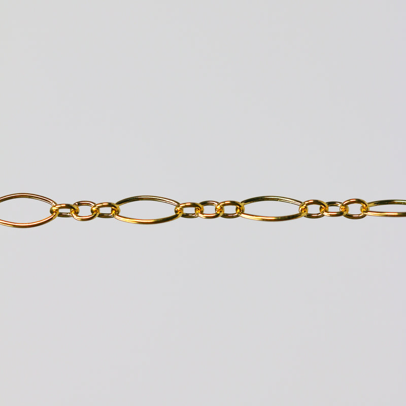 Gold oval chain on a light gray background