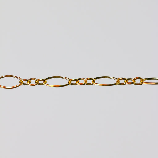 Gold oval chain on a light gray background