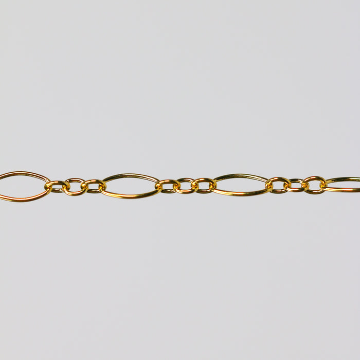 Gold oval chain on a light gray background