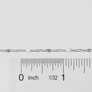 Silver bracelet with a ruler for scale on a light gray background