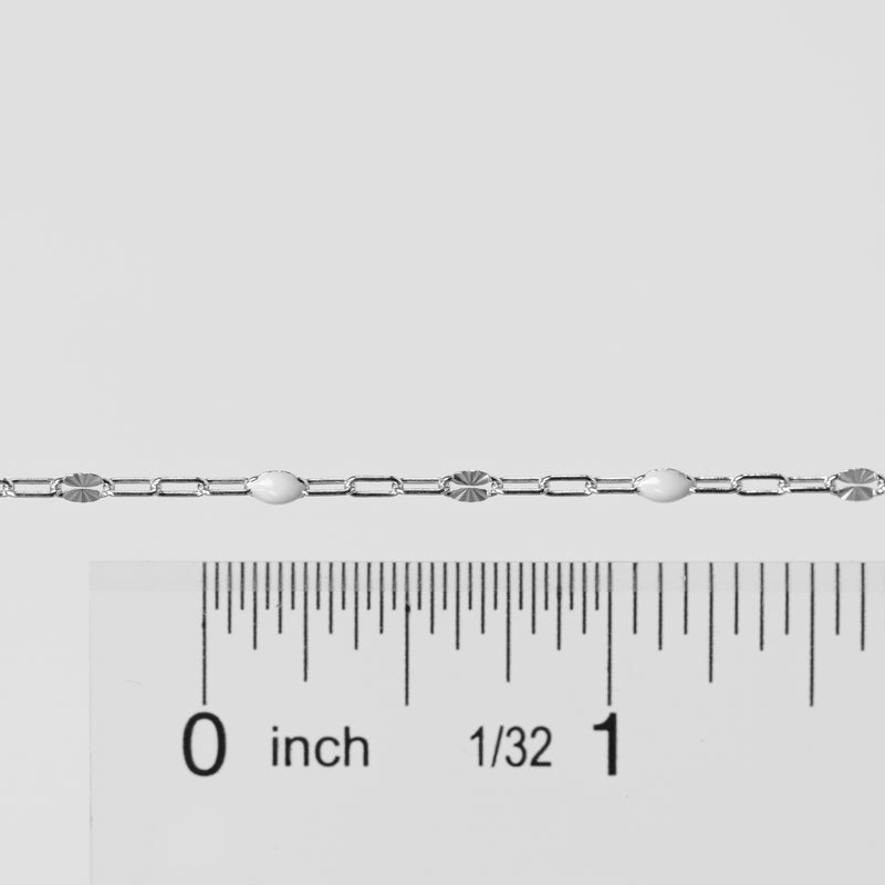 Silver bracelet with a ruler for scale on a light gray background