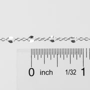 Silver bracelet with a ruler showing its measurement on a white background