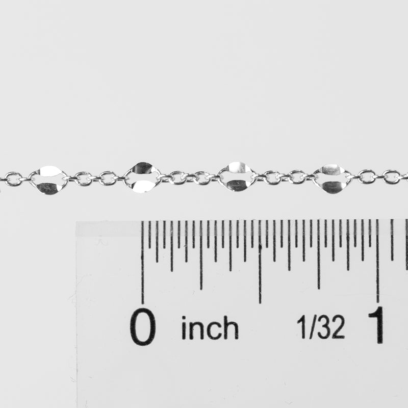 Silver bracelet with a ruler showing its measurement on a white background