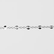 Silver bracelet with hammered links on a light gray background