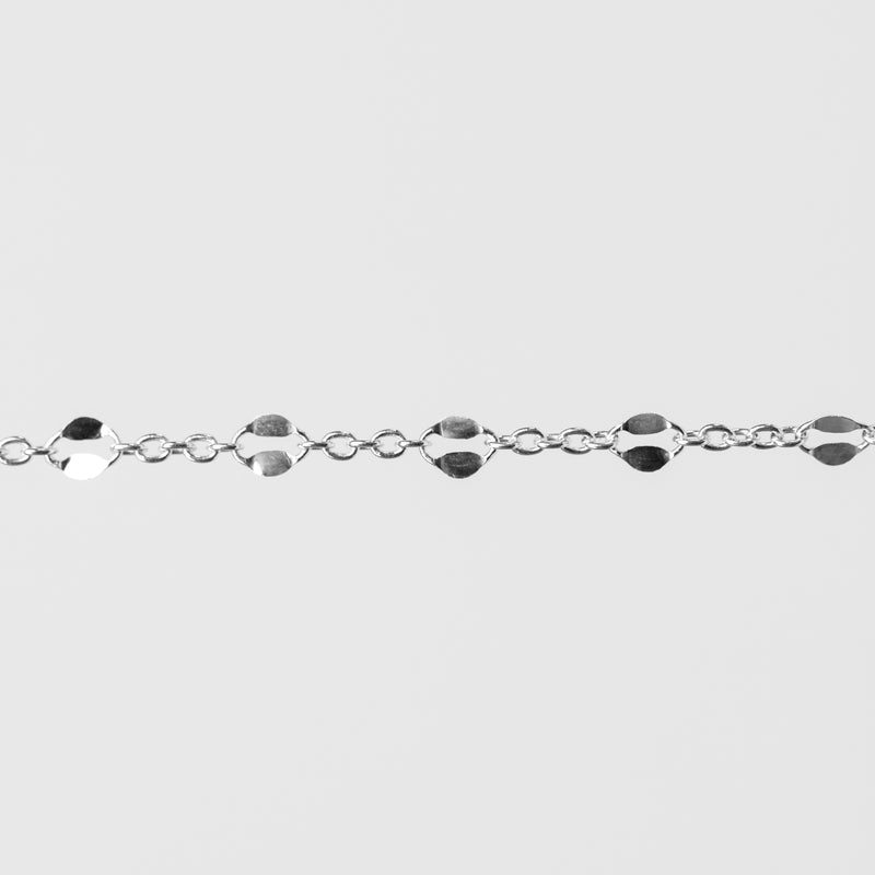 Silver bracelet with hammered links on a light gray background