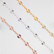 Three delicate chain bracelets in yellow gold, silver, and rose gold, each featuring a row of alternating small round and large hammered links, displayed against a clean white background.