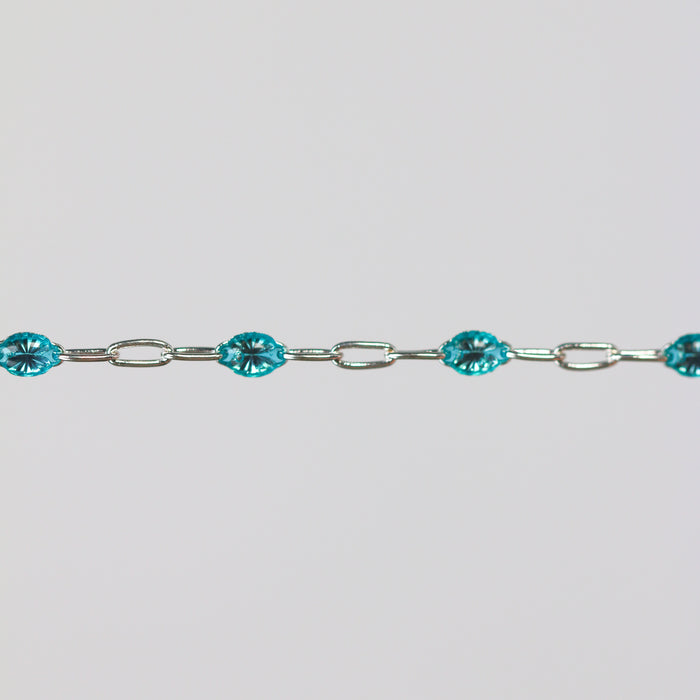 Sparkly silver chain with teal enamel on it.