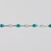 Sparkly silver chain with teal enamel on it.