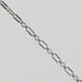 Silver rolo chain on a light gray background