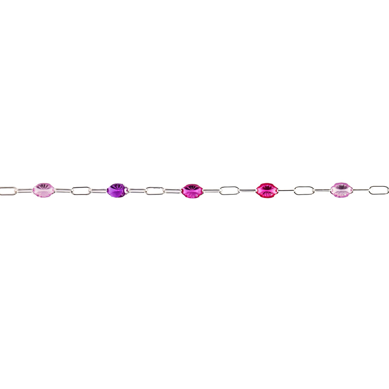 A silver permanent jewelry chain featuring alternating oval purple enamel, displayed horizontally against a solid white background.